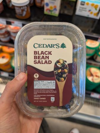 container of Cedar's black bean salad showing same ingredients as Aldi's