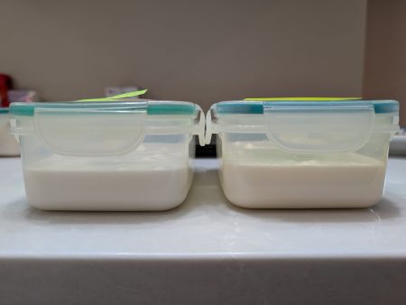 two clear containers of vegan royal icing showing that pure vanilla extract plus violet food coloring yields a brighter product than clear vanilla extract and white food coloring