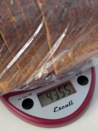 Tomato Basil Bread from Panera sitting atop a food scale which reads 43.55 oz