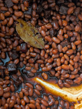 close-up of vegan Boston baked beans sauce when done. A clean line remains where a spoon was dragged through