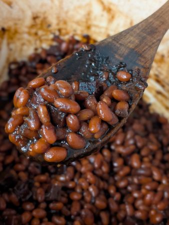 close-up of spoonful of vegan Boston baked beans